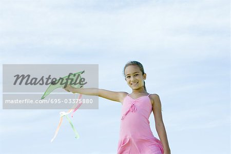 Girl holding up kite