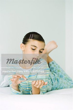 Girl lying on stomach, filing nails