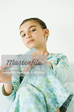 Girl filing nails