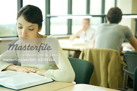 Young woman studying in university library