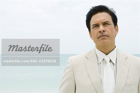 Businessman, sea in background