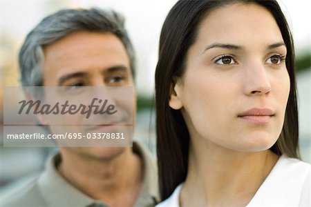 Couple looking away, focus on woman in foreground