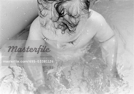 Baby in bathtub, elevated view, b&w