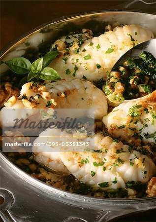 Filets of monkfish in dish with herbs, close-up