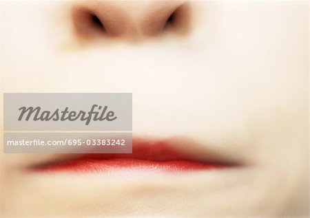 Close up of woman's pursed lips, blurry.