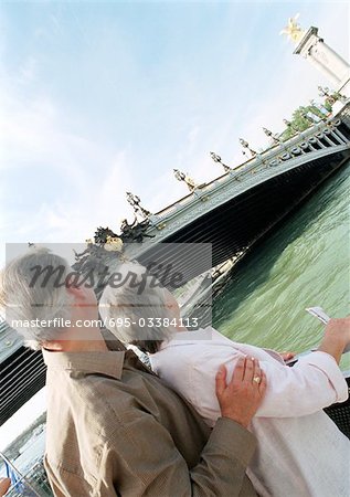 France, Paris, mature woman and man looking at the Pont Alexandre III