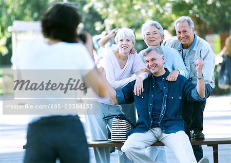 Group of mature people having their photo taken, blurred foreground
