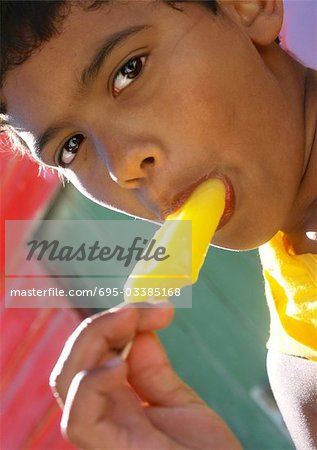 Boy eating popsicle, close-up