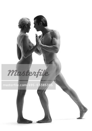 Nude man and woman dancing, side view, b&w