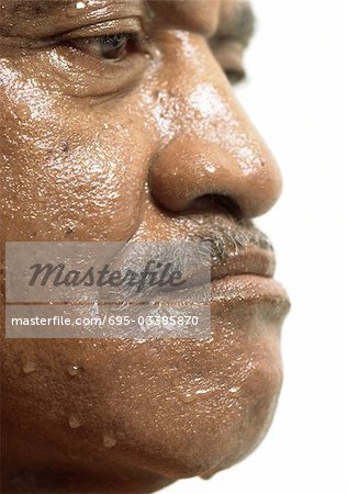 Senior man with wet face, side view, close up.