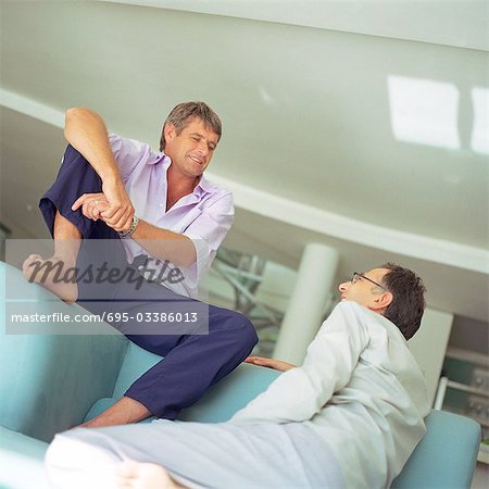 Two men sitting on sofa