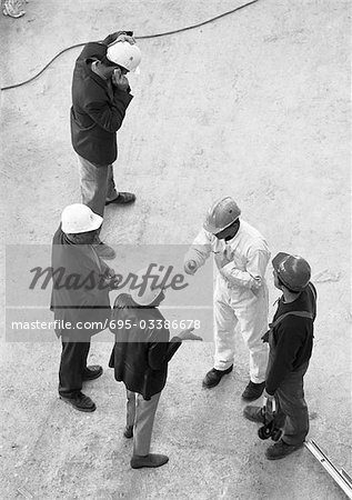 Five people wearing hard hats, elevated view, b&w
