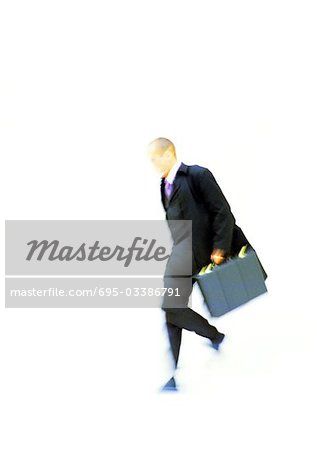 Businessman walking with briefcase in hand, elevated view