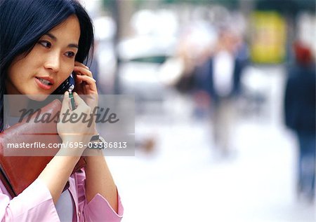 Businesswoman using cell phone, close-up