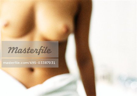 Semi-nude woman with bath towel around waist, blurred close-up.
