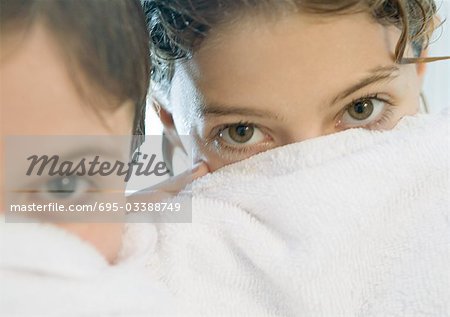 Two girls looking over edge of towel
