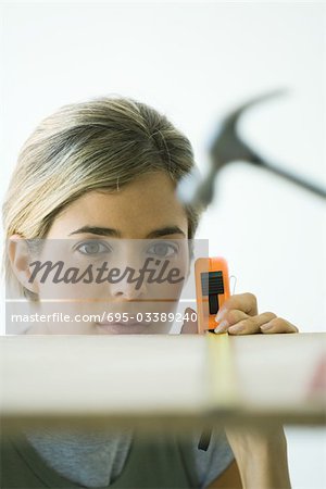 Woman measuring wooden board