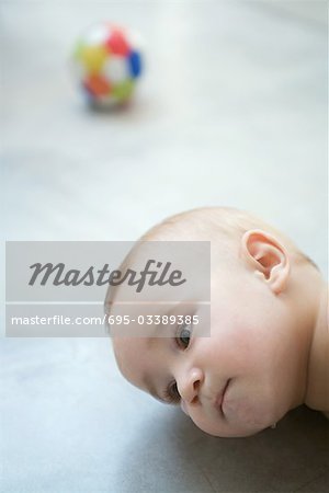 Baby lying on floor, head, close-up