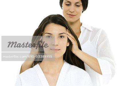 Woman receiving head massage, looking at camera