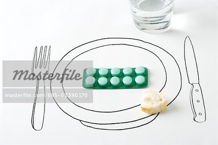 Blister pack of pills and small piece of bread on drawing of plate