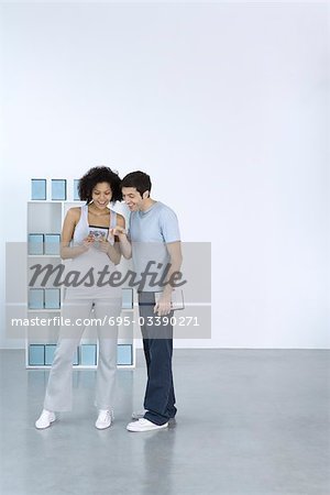 Man and woman looking at DVD together, smiling