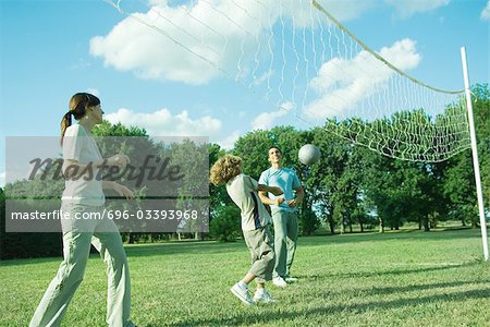 Family outdoors playing volleyball