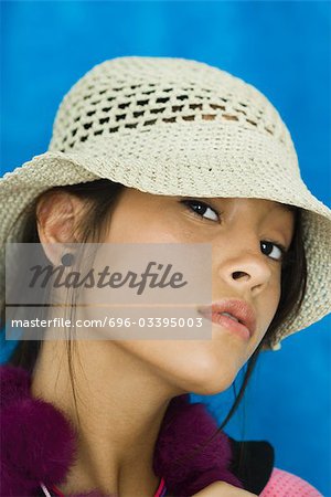 Teenage girl wearing hat, looking at camera, portrait