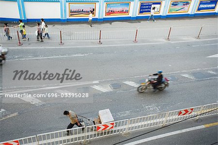 Pedestrians and motorcyclist on street, high angle view