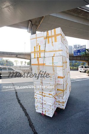 Stack of polystyrene boxes on asphalt