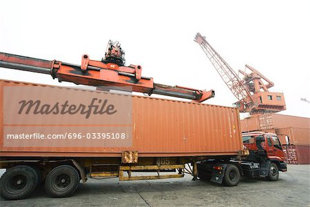 Cargo container being loaded onto truck