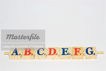 Wooden alphabet blocks in a row, close-up