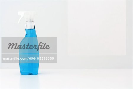 Spray bottle filled with blue cleaning fluid