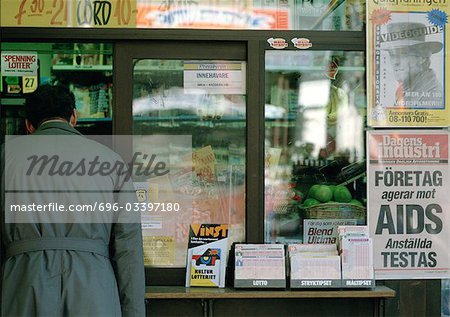 Sweden, man standing at shop window, rear view