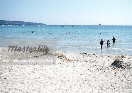 France, Corsica, people wading at beach