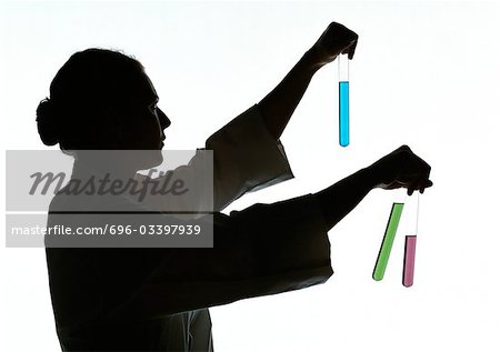Woman holding test tubes containing different colored liquids, silhouette.