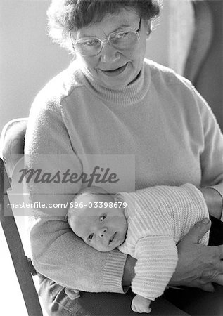 Mature woman holding baby, b&w
