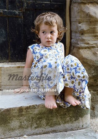 Little girl sitting on stairs