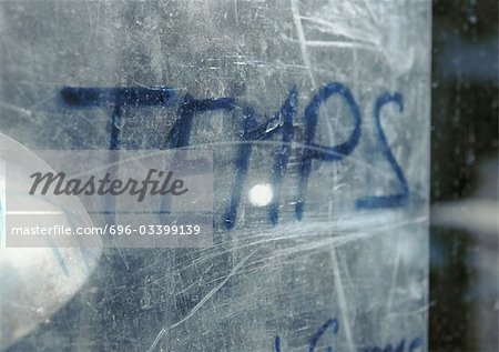 Time text in French written on scratched surface, close-up