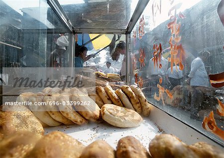 China, Beijing, meat pastires in glass display in street market