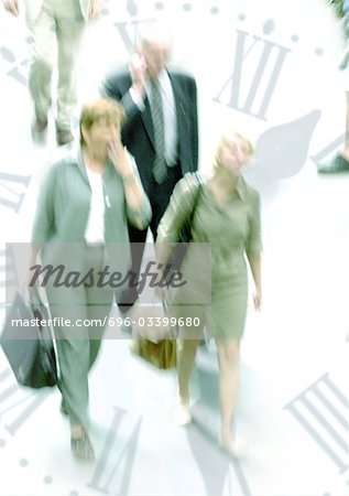 Businesspeople walking through clock, montage