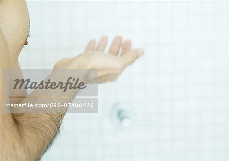 Man holding out hand in shower