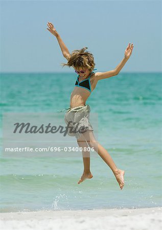 Girl jumping on beach