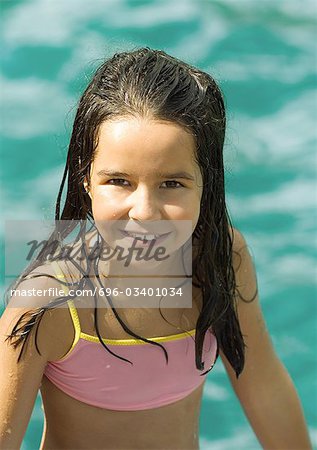 Girl in bathing suit, water in background, portrait
