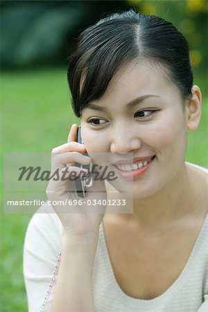 Woman using cell phone, close-up