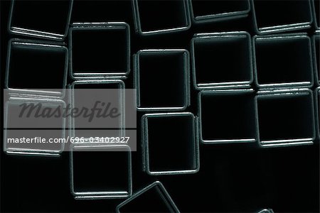 Staples forming squares on black background, close-up