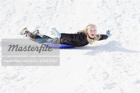 Girl Sledding in Winter