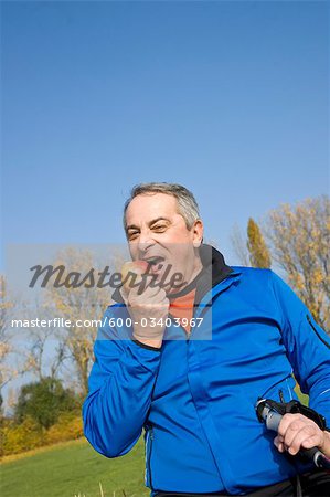 Mature Man Eating Apple Outdoors