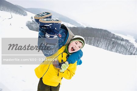 Two Boys Playing Outdoors in Winter