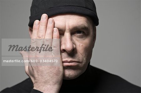 Man Covering One Side of His Face