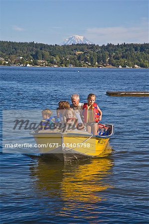 men and young children on motorboat ride